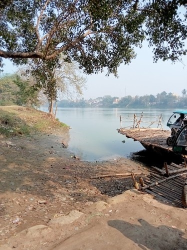 ShadedBankAwaitsRiverFerry